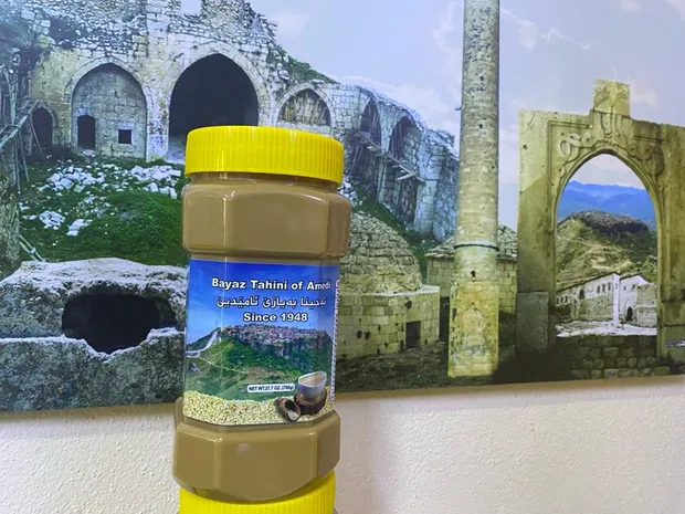 Bayaz Tahini jar in front of the historic architecture of Amedi